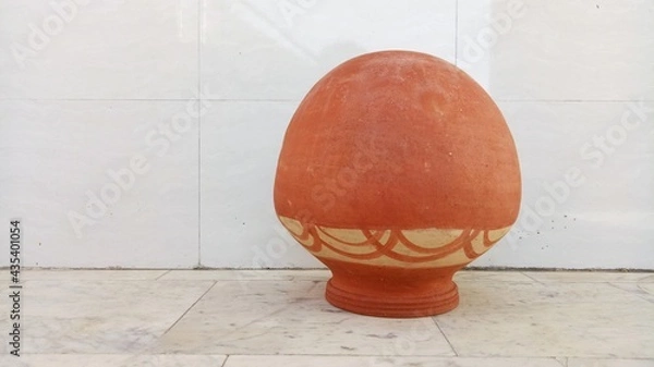 Obraz round earthen pot with white background