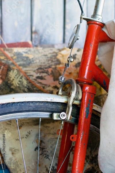 Fototapeta Wheel and part of the handlebars of old red bicycle