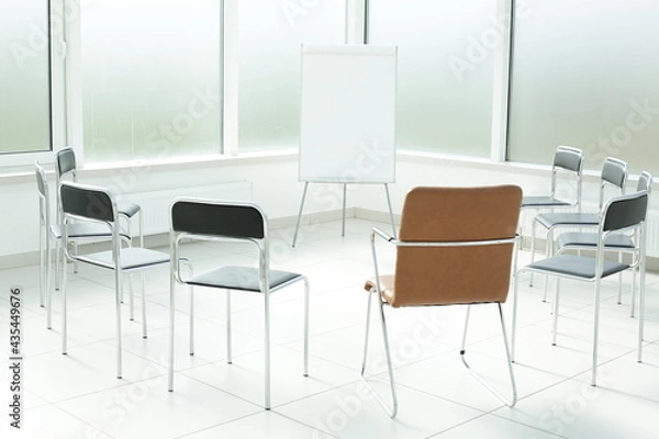 Fototapeta Flipchart and chairs in a bright office space