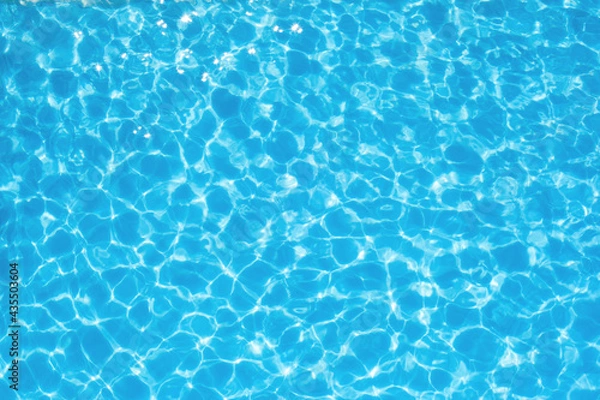 Obraz The water ripples in a blue transparent pool. Waves and ripples in the pool.