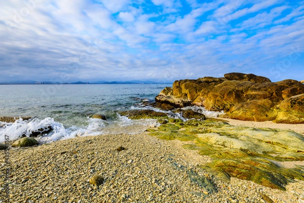 Obraz Landscape with beach,the sea and the beautiful clouds in the blue sky.rocks on the beach.