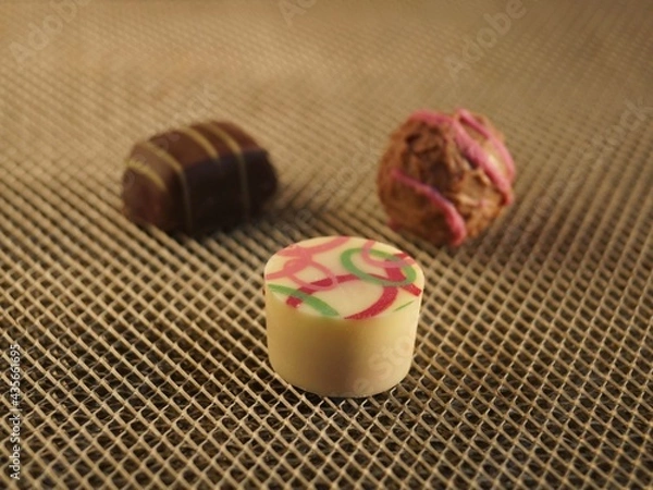 Obraz Three chocolate colored candies 