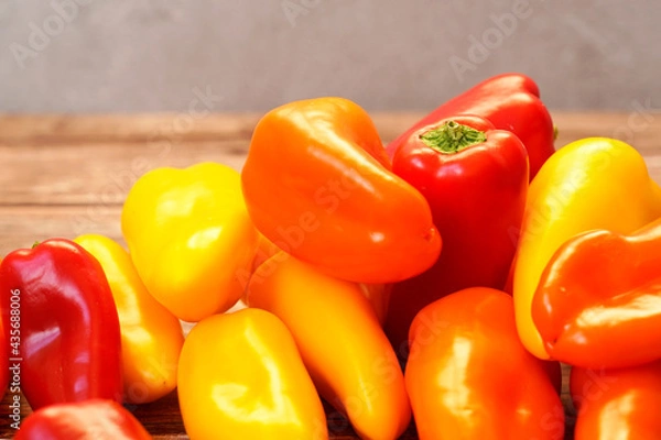 Fototapeta Close up of colorful orange, red and yellow peppers paprika background