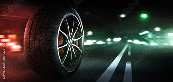 Fototapeta Autoreifen auf einer beleuchtetetn Strasse