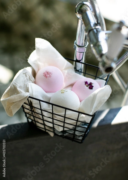 Obraz 
Bath bombs pink and white in a basket on the bathroom