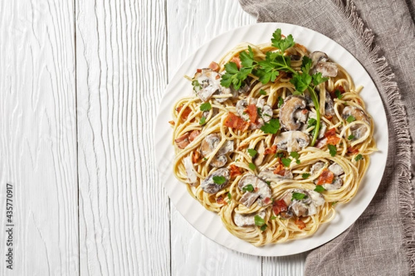 Fototapeta Spaghetti with mushrooms on a plate, copy space