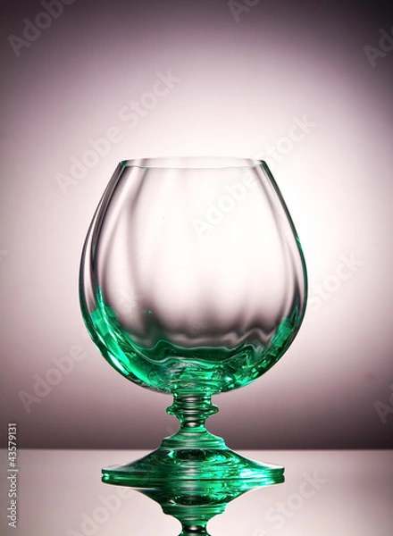Fototapeta Empty cognac glass with a green tint