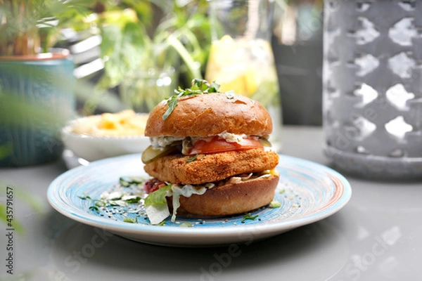 Fototapeta Vegetarian burger with tofu cheese and vegetables. A colorful appetizing dish. Culinary photography, food styling.