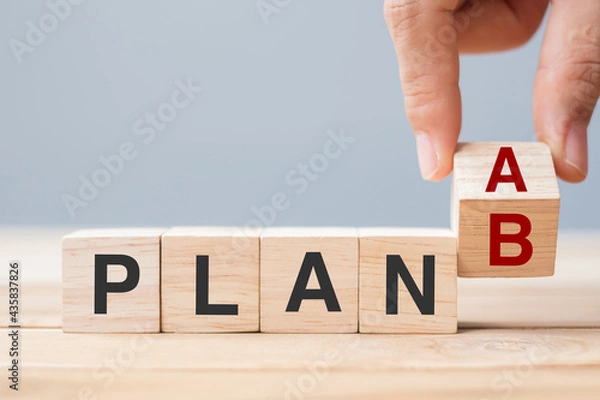 Fototapeta Businessman hand flipping wooden cube blocks with PLAN A change to PLAN B text on table background. strategy, leadership, management, marketing, project and Crisis concepts