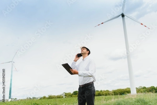 Fototapeta Engineer inspecting Project Manager at the Wind Farm. Man working in the enviromental