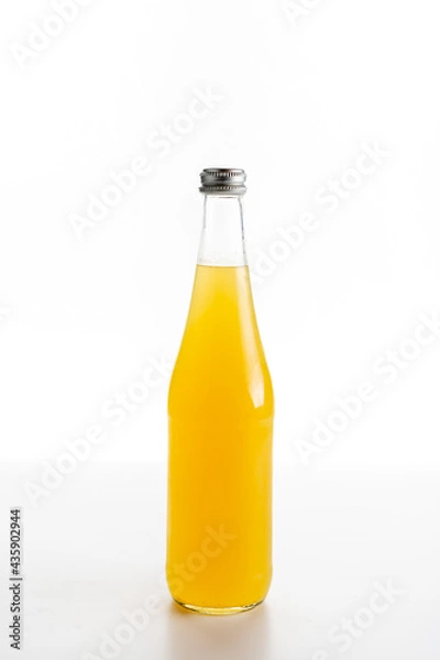 Fototapeta glass bottle of orange lemonade on a white background
