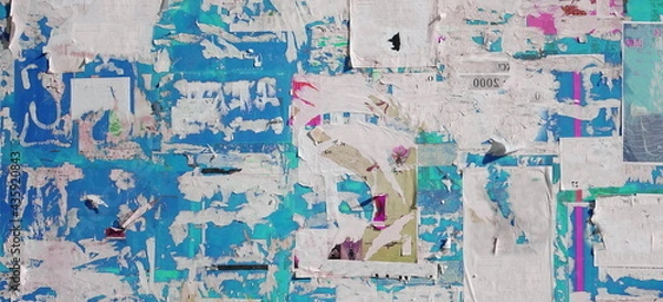 Fototapeta Artistic Urban Street Background with Grungy Wall with Ripped, Torn And Peeled Posters. Old Wall with Scratched Advertising. Old Billboard with Torn Posters. Vintage Wide Background and Texture.