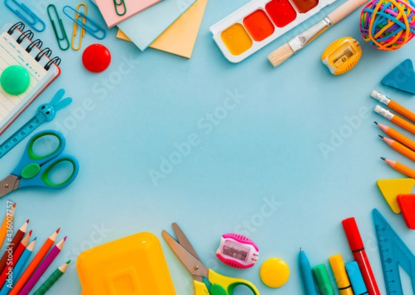 Fototapeta School supplies stationery on a blue background, back to school concept with copy space for text, flat lay, top view, mockup,
