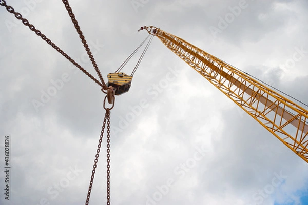 Fototapeta Crane boom with rope, hook and chains.