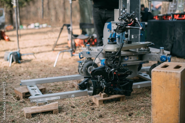 Fototapeta Professional film and video camera on the set. Shooting shift, equipment and group. Modern photography technique.