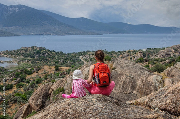Obraz Mom and daughter stand high on the mountain and enjoy the view of a beautiful valley in turkey