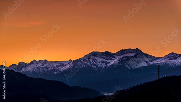 Obraz Sunrise over the Garibaldi Mountain Range with the northern most peak of Mt. Currie in the range in the distant. Viewed from Whistler RV Park plateau, British Columbia, Canada