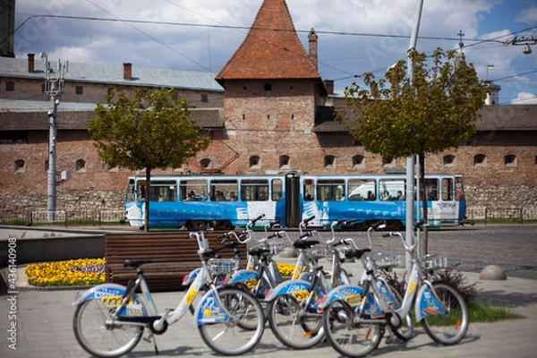 Obraz Bicycles, tram on the background of the Bernardine monastery in the old city of Lviv
