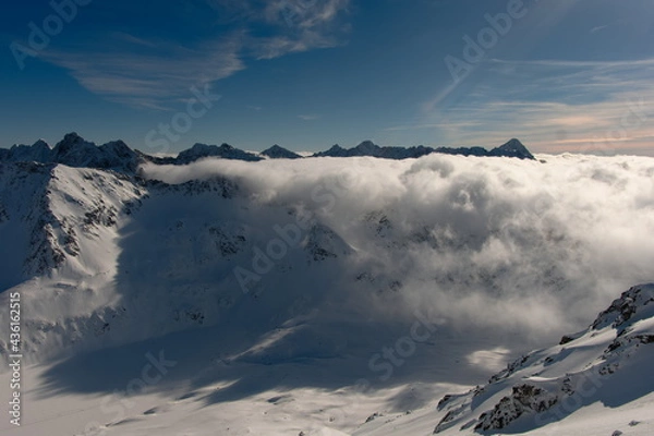 Obraz Clouds rolling over the mountain pass. Clouds in a mountain valley.