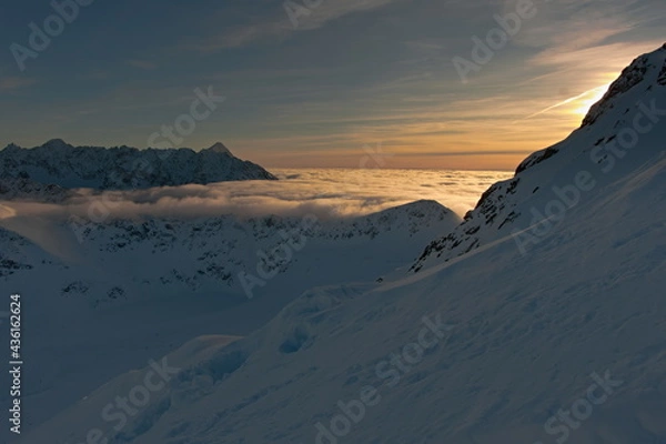 Obraz Colorful sky in the mountains during the elephant sunset. Sunset in the mountains. Clouds in a mountain valley.