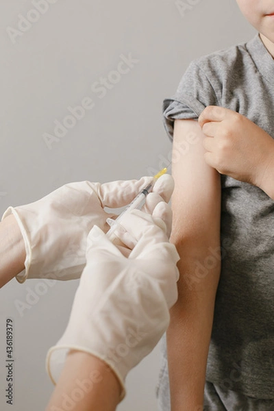 Fototapeta Close up Hands preparing vaccination shot to shoulder of patient