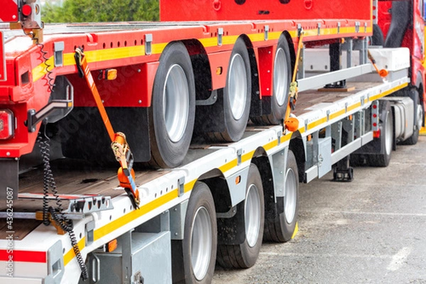 Obraz Long cargo vehicle platform, load securing and load holding with a belt.