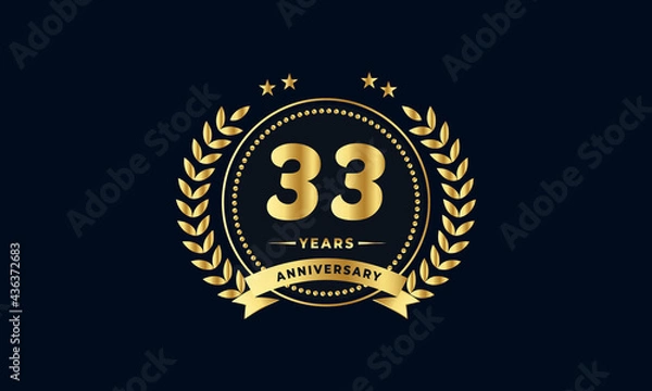 Fototapeta 33th golden anniversary logo, with shiny ring and golden ribbon, laurel wreath isolated on navy blue background