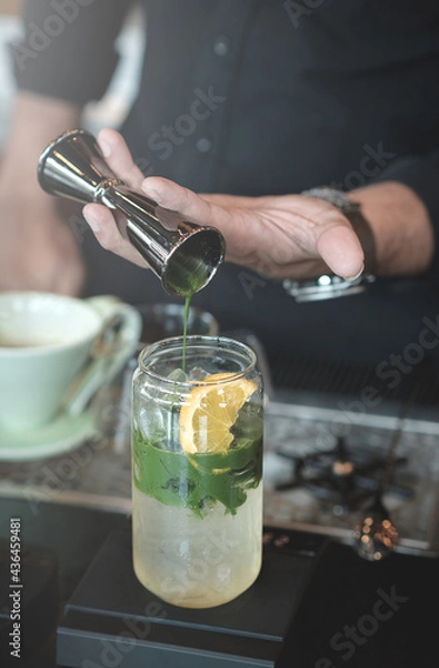 Fototapeta Green tea poured over lemon and Yuzu soda.