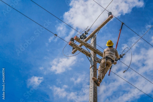 Fototapeta The power lineman use clamp stick (insulated tool) to closing a transformer on energized high-voltage electric power lines. The power lineman must be trained because it is a risky job