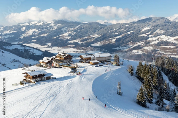 Fototapeta Elevated view of hotel and restaurant buildings  on the slopes at Kirchberg in Tirol, part of the Kitzbühel ski area in Austria.