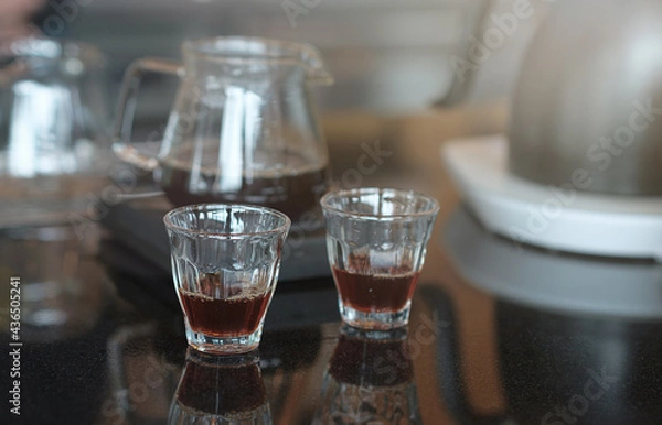 Fototapeta The drip coffee is ready to be served in a cup on the table.