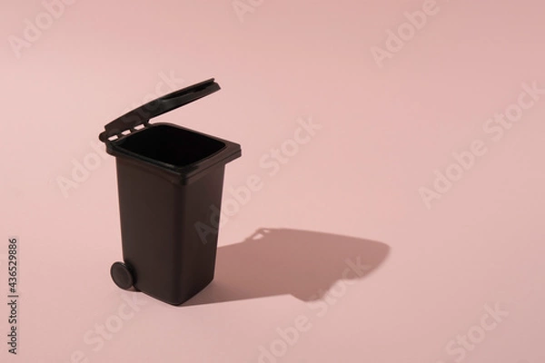 Fototapeta A creative trash can concept on a pink background