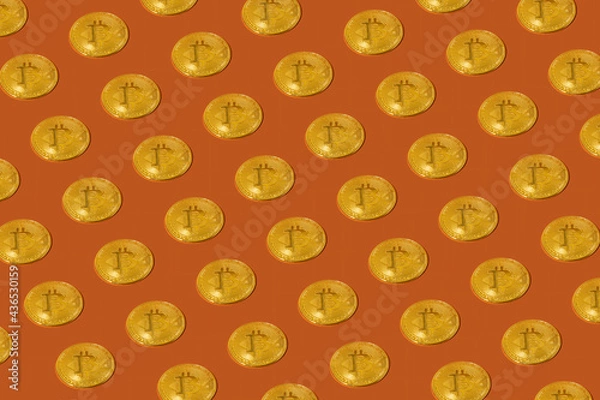 Fototapeta Abstract sample Gold bitcoin is placed on an orange background.