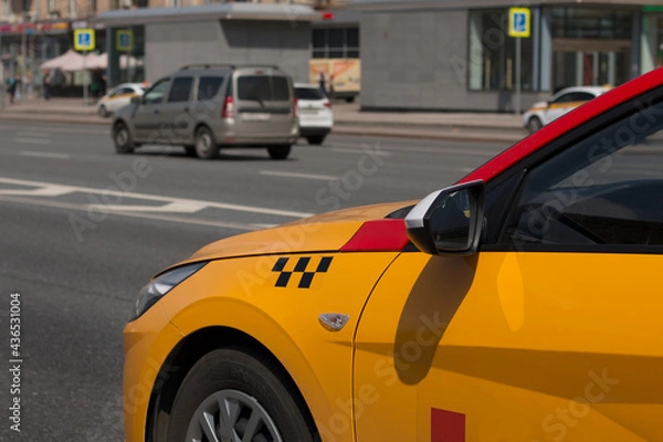 Obraz Yellow taxi with checker pattern, close-up view. Yellow taxi cab on the street of downtown
