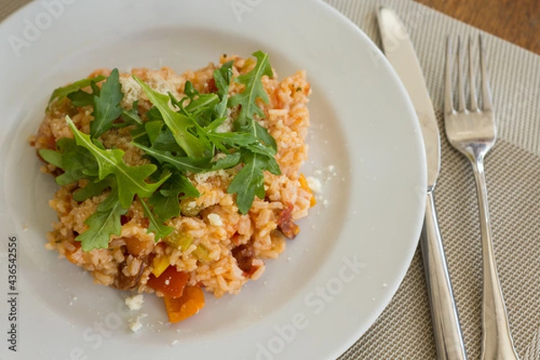 Fototapeta Mediterranean dish with rice, vegetables and arugula on a plate