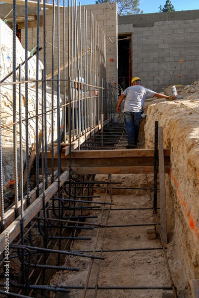 Fototapeta Installing vertical rebar on a new structural footing
