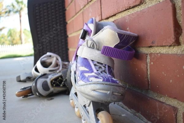 Obraz roller blades against brick wall