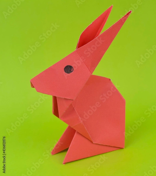 Fototapeta Single little rabbit made with small craft paper and nicely placed on a paper background