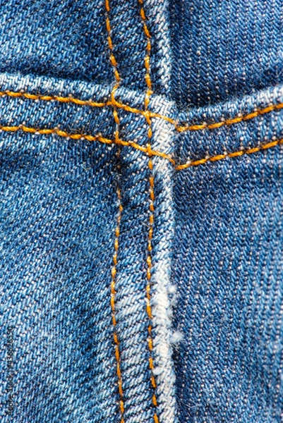 Obraz Detail of old blue jeans with yellow seams. Texture closeup background