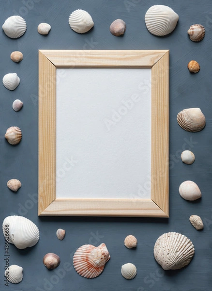 Obraz Sea vacation stationery mock-up scene. Blank white greeting card in wooden frame surrounded by colorful sea shells on textured gray background.