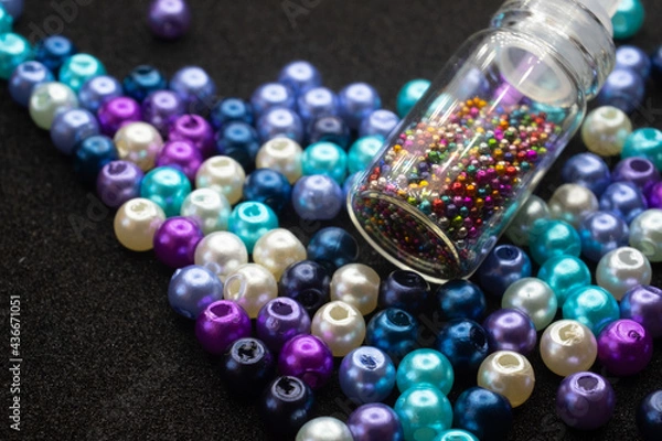 Fototapeta beads and bottles on a black background