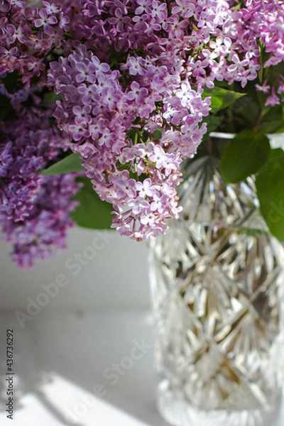 Obraz Vase with a bouquet of lilacs on the window.