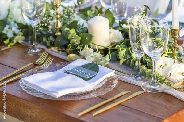 Fototapeta Romantic Wedding Table Top Layout Table Spread no people no human tropical location with gold cutlery and scenic view