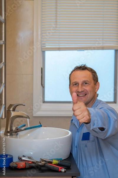 Obraz Plumber repairs bathroom sink