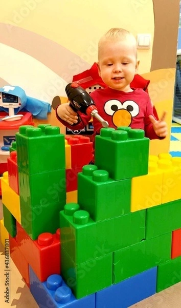 Obraz a child plays with a toy constructor