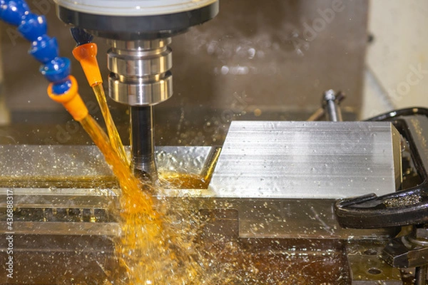 Fototapeta The CNC milling machine cutting the  tire mold parts with oil coolant method. The mold and die manufacturing process by CNC machining center.