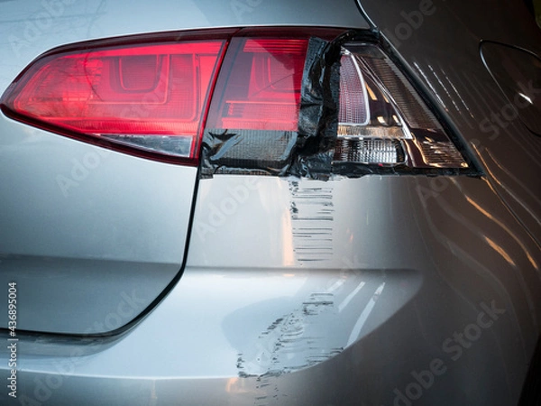 Obraz Car damages in rear part of the vehicle close up. Smashed turn signal