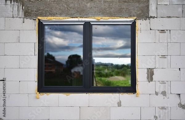 Fototapeta plastic window mounted on a building under construction
