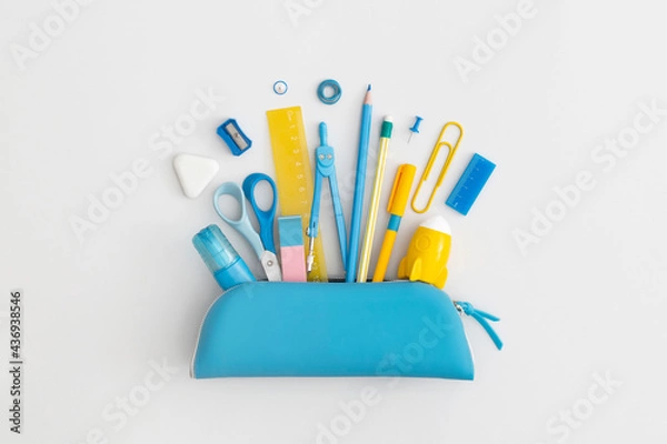 Fototapeta Pencil case with school stationery on a grey background. Top view. Flat lay. Back to school concept.