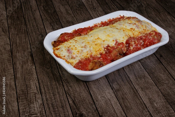 Obraz Steak Parmegiana or Parmegian Filet, made with breaded steak, tomato sauce, mozzarella cheese and Parmesan cheese.Photo with free space for text on the left.